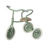 Green children's tricycle with wooden seat on a white background
