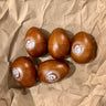 Wooden eggshakers on a brown paper background 