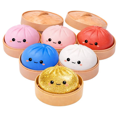 Set of colorful bun-shaped squishies with faces in a steamer-like container on a white background