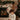 Child by a fireplace with Christmas stockings and tree
