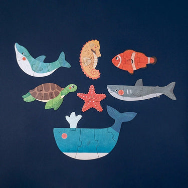 Puzzle pieces of sea animals on a blue background 