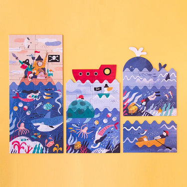 Children's puzzle in four sections with pirate and whale designs on a yellow background