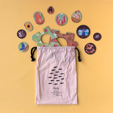 Puzzle pieces coming out of a cotton drawstring bag on a yellow background 