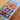 Reversible puzzle packaging with tree and house design on a yellow background