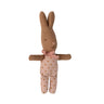A handmade fabric bunny plush toy in brown with a pink polka-dot bodysuit and a pink knotted bow, shown against a plain white background.