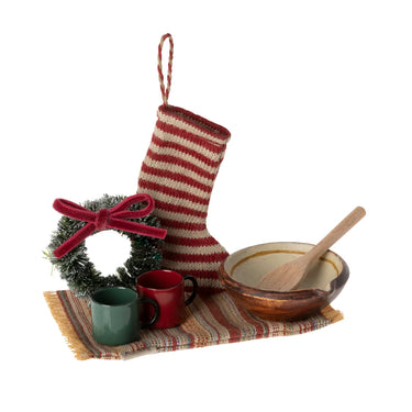 Decorative Christmas set with a striped stocking, wreath, mugs, bowl, and spoon on a white background