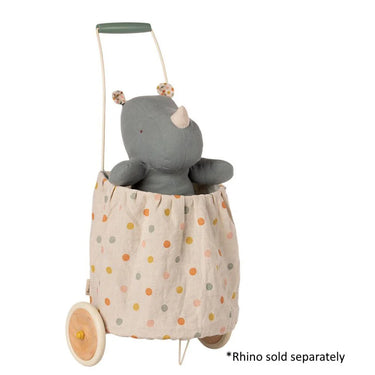 Toy rhino in a polka dot bag with wheels on a white background