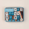 A memory card game in a tin on a beige background