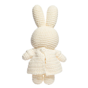 Knitted cream-colored bunny toy on a white background
