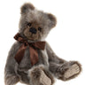 Stuffed teddy bear with a brown bow tie on a white background