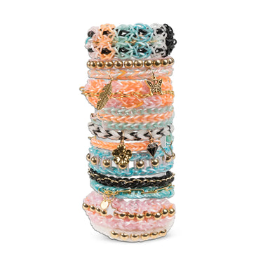 Stack of colorful beaded bracelets with charms on a white background