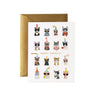 Birthday card with illustrated cats wearing party hats and accessories on a white background.