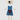 Stuffed koala toy in a blue dress, white shirt and maroon pocket on a white background