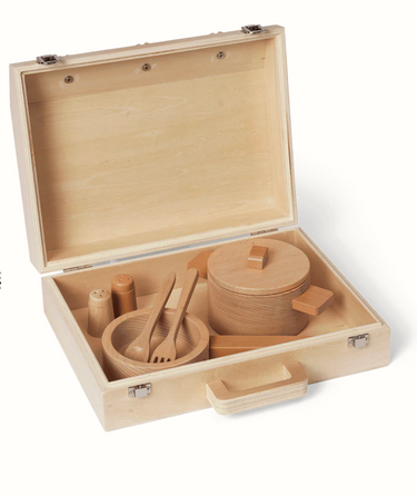 Toy wooden kitchen with wooden utensils in a portable wooden case on a white background