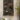 Wall-mounted garden tool organizer with various gardening tools on a textured wall.