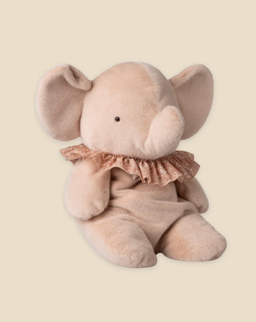 Plush elephant toy with a ruffled collar on a beige background