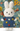 Crocheted bunny toy in a blue dress with floral patterns on a floral background