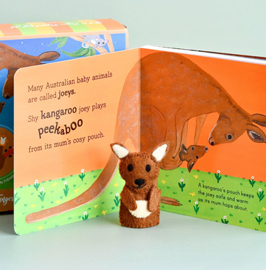 Children's book about kangaroos with a felt kangaroo finger puppet on a light blue background