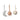 Three Ferm Living soft fabric baby hanging toys on a white background: a pale gray crescent moon, a dusty peach star, and an off-white round ball with small star cutouts.