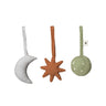 Three Ferm Living soft fabric hanging toys on a white background: a pale gray crescent moon, a terracotta starburst, and a sage green oval with small white dots.