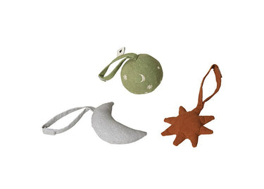 Three Ferm Living fabric hanging ornaments on a plain white background: a light olive-green round ornament with a small white moon and star, a pale gray crescent moon with a loop, and a rust-orange star with a loop.