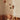 Baby in a crib with a Ferm Living mobile above, featuring stars and planets.