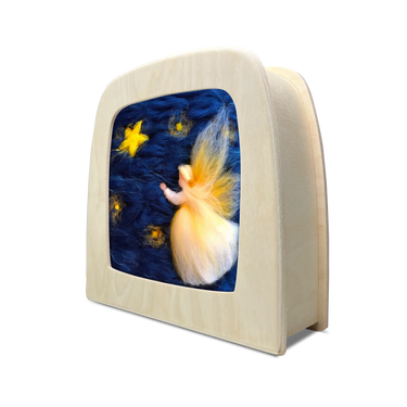 A Toverlux lamp with a natural wood frame displaying an angel in a starry night sky. 