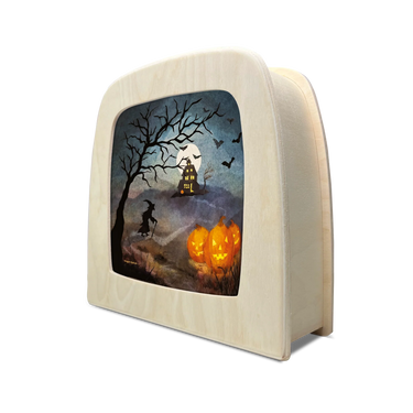 A wooden lamp with a curved front panel featuring a Halloween scene illustration, including a witch riding a broomstick, a haunted house, bats, and glowing jack-o'-lantern pumpkins, shown on a white background.