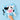 A baby sensory book with a cow face design, held by a child's hand against a solid light blue background.