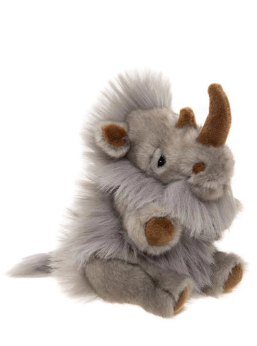 A plush stuffed animal resembling a small gray creature or monster with brown horns, ears, and hooves, photographed on a plain white background.