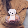 Person holding a small white bear-shaped night light