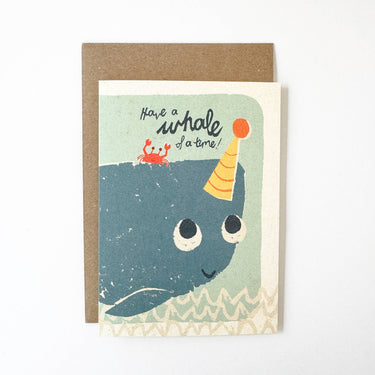 Greeting card with a whale illustration and text 'Have a whale of a time' on a white background.
