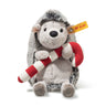 Plush hedgehog toy with a red and white striped scarf on a white background