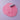 Pink play dough with embossed decorative motifs shown with a small purple roller on a light lavender background.