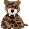 A plush toy of a spotted big cat, resembling a leopard or jaguar, with brown and black spots, a white muzzle, and small white tusks, isolated on a white background.