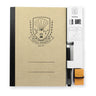 A chalkboard set on a white background, featuring a kraft paper cover with a black spine and a black line-art crest that reads 'Nihon Rikagaku since 1937'. To the right, a white plastic organizer sleeve holds a chalk pen and an orange eraser.