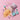 A stand-up pouch labeled 'WONDER DOUGH MIX' lies on a pink background with spilled orange powder and pastel dough-like pieces arranged around it. The pouch is pale pink and white, and the scene includes decorative pastel shapes in teal, lavender, mint, and pink.