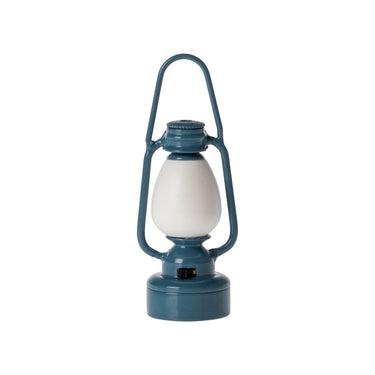 A vintage-style lantern with a teal blue metal frame and base, and a frosted white glass bulb, isolated on a white background.