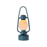A teal blue vintage-style lantern with a glowing warm yellow light inside, shown against a plain white background.
