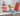 Toy Maileg mouse with a sailboat and lighthouse on a shelf