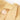 Close-up of a beige garment with fringes and a label on a white background
