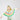 A child wearing a colorful rainbow fringe cape and a matching green cap, photographed from behind against a plain light gray studio background.