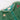 A close-up of a green tulle costume with a ruffled neckline, gold button, star-shaped embellishment, and a red-and-white striped candy cane detail, shown on a light gray background.