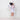 Child wearing fairy wings and holding a wand against a white wall