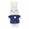 White crocheted Miffy bunny toy with a blue dress featuring yellow stars on a white background