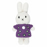 White crocheted bunny toy with a purple dress on a white background