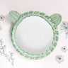 Mint green rattan mirror with bear ears on a light background