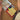 Colorful crayons in a Stockmar box with a child's drawing on a wooden surface