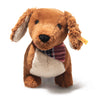 Plush dachshund dog toy with a plaid scarf on a white background
